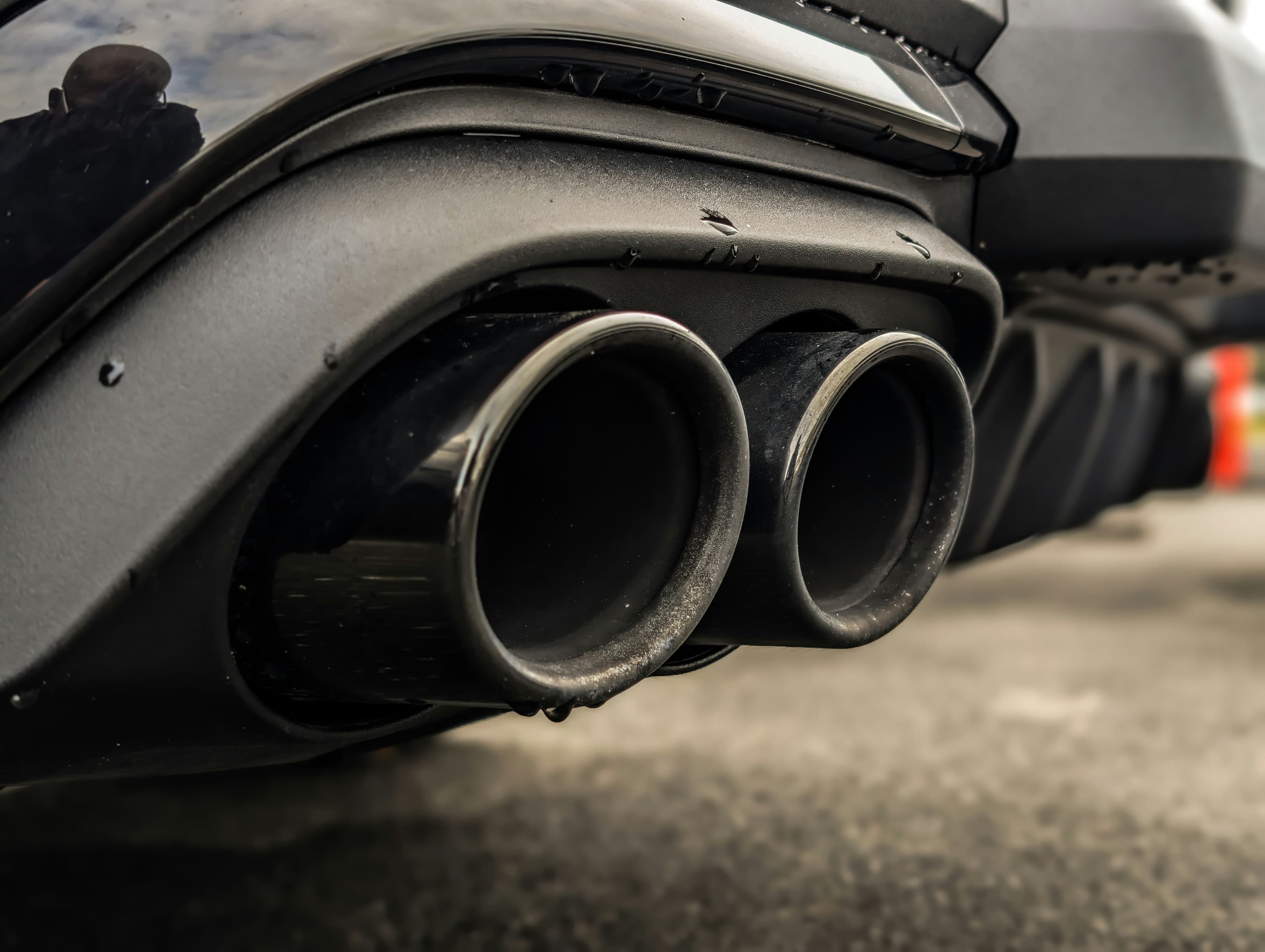 Close up of a car exhaust system being replaced